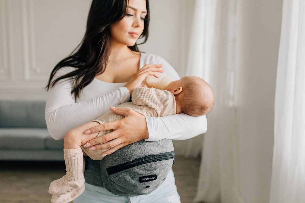 Women holding baby using tushbaby gray ::[15109665390658]