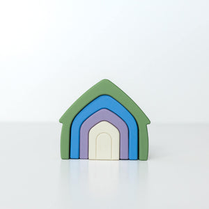 Blues Playhouse Stacker with nested green, blue, purple, and cream silicone arches on a white background