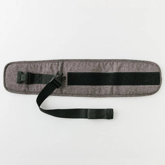 The Waistband Extender in Charcoal laid flat, showing the adjustable black strap, buckle, and hook-and-loop fastening panel