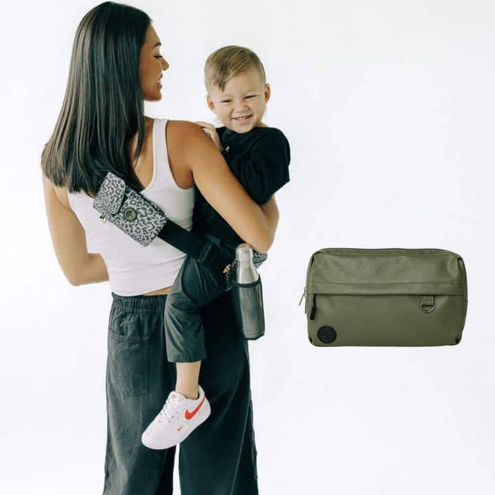 Rear view of an adult carrying a child in the Jaguar Tushbaby Liftoff Toddler Sling beside the Olive Tushbaby Pack
