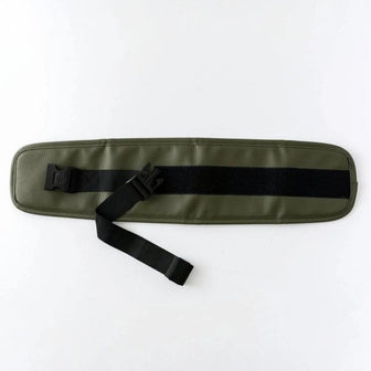 The Waistband Extender in Olive laid flat, showing the adjustable black strap, buckle, and hook-and-loop fastening panel
