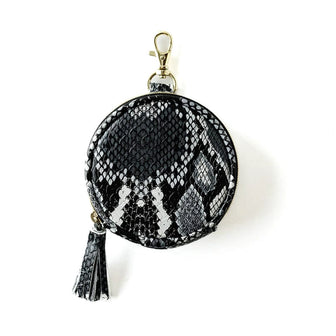 The Pod in Python with a snakeskin pattern, gold-tone clip, and tassel zipper pull on a white background