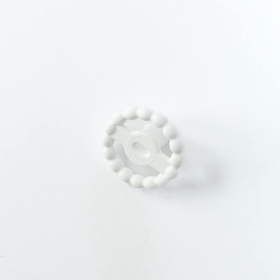 Front view of a White Orthodontic Pacifier with a beaded teether ring on a white background